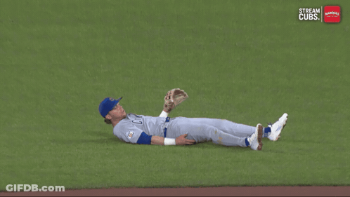 A Baseball Player Is Laying On The Ground With The Words Stream Cubs On The Bottom GIF