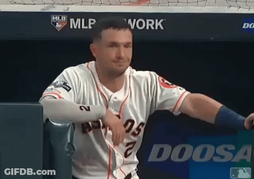 A Baseball Player Is Leaning Against A Wall With A Doosa Logo In The Background GIF