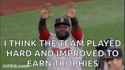 A Baseball Player Is Raising His Hands In The Air While Wearing A Red Sox Uniform . GIF