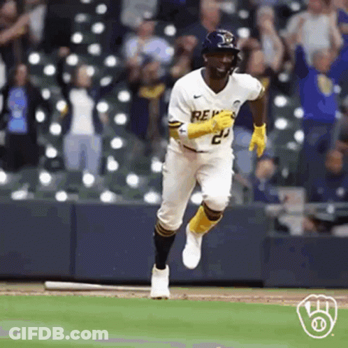 A Baseball Player Is Running On A Baseball Field With A Bat . GIF