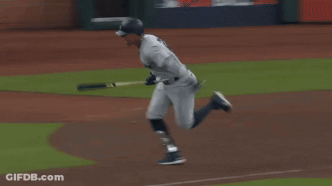 A Baseball Player Is Running On A Field With A Sign That Says ' A ' On It GIF