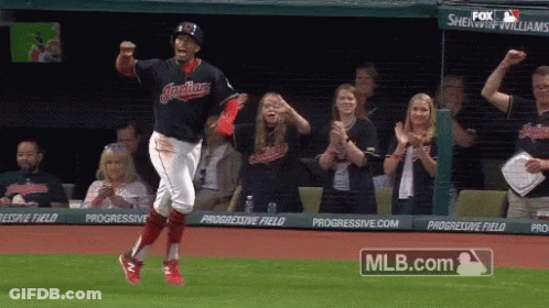 A Baseball Player Is Running On The Field With A Mlb.com Logo Behind Him GIF