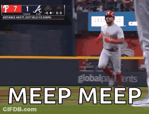 A Baseball Player Is Running On The Field With The Words Meep Meep Written On The Screen Behind Him . GIF