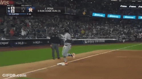 A Baseball Player Is Running To The Base During A Game . GIF