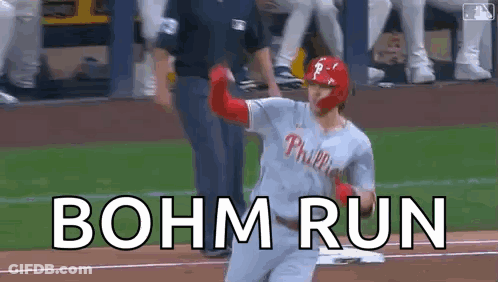 A Baseball Player Is Running Towards Home Plate With The Words Bohm Run Written On The Ground . GIF