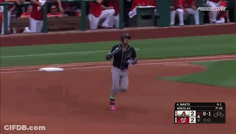A Baseball Player Is Running Towards The Base During A Game GIF