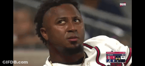 A Baseball Player Is Sitting In The Dugout Watching A Game GIF