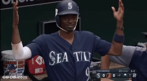 A Baseball Player Is Sitting In The Dugout With A Bank Of America Banner Behind Him GIF