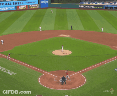 A Baseball Player Is Sliding Into Home Plate While A Referee Looks On GIF