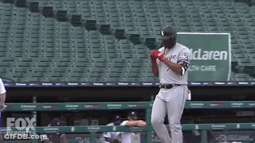 A Baseball Player Is Standing In Front Of A Green Sign That Says Mclaren Healthcare GIF