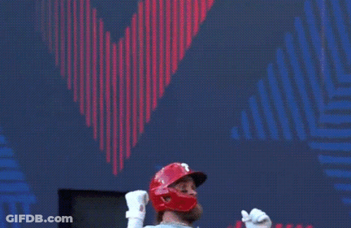 A Baseball Player Is Standing In Front Of A Scoreboard . GIF