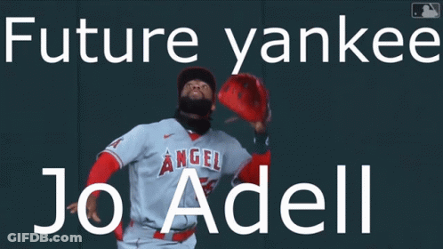 A Baseball Player Is Standing In Front Of A Wall That Says Future Yankees Jo Adell GIF