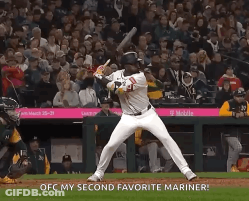 A Baseball Player Is Swinging A Bat At A Ball And Says Ofc My Second Favorite Mariner GIF
