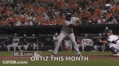 A Baseball Player Is Swinging A Bat At A Ball And The Words Ortiz This Month Are Above Him GIF