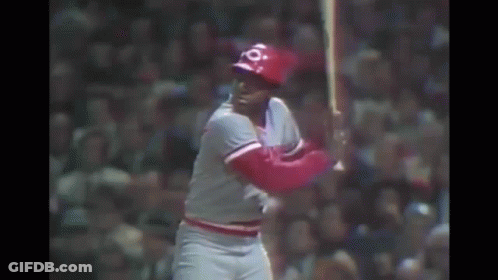 A Baseball Player Is Swinging A Bat At A Ball In A Baseball Game . GIF