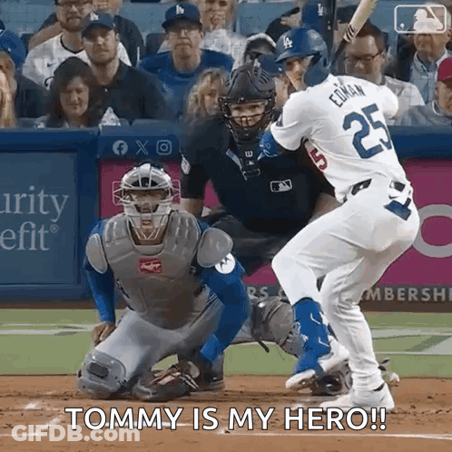 A Baseball Player Is Swinging A Bat At A Ball While A Catcher Watches And Says Tommy Is My Hero . GIF