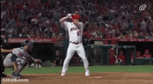 A Baseball Player Is Swinging A Bat At A Ball While A Catcher Watches . GIF