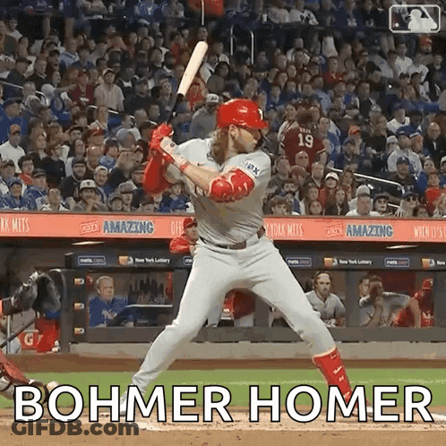 A Baseball Player Is Swinging A Bat At A Ball With The Words Bohmer Homer Written On The Field . GIF
