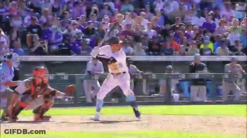 A Baseball Player Is Swinging A Bat At A Pitch While A Catcher Watches . GIF