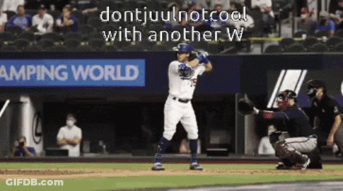 A Baseball Player Is Swinging At A Pitch In Front Of A Banner For Camping World GIF