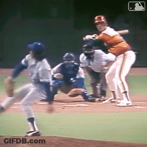 A Baseball Player Is Swinging His Bat At A Ball GIF