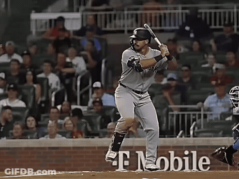 A Baseball Player Is Swinging His Bat In Front Of A T Mobile Sign GIF