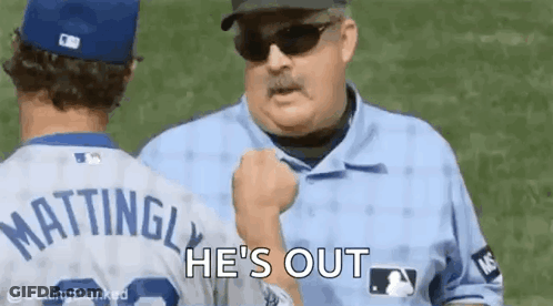 A Baseball Player Is Talking To A Referee On A Baseball Field . GIF