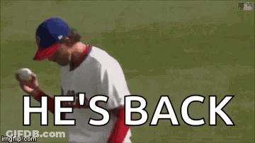 A Baseball Player Is Throwing A Ball And The Words `` He 'S Back '' Are Written On The Screen . GIF