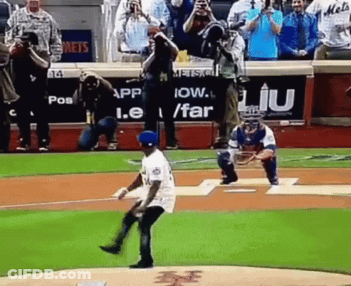 A Baseball Player Is Throwing The First Pitch Of A Game While A Catcher Watches . GIF