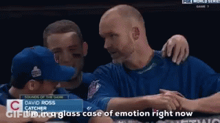 A Baseball Player Named David Ross Is Hugging Another Player GIF