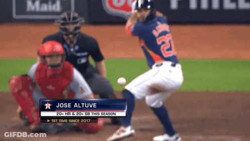 A Baseball Player Named Jose Altuve Is Swinging At The Ball GIF