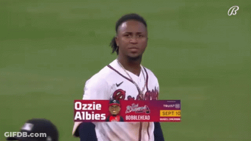 A Baseball Player Named Ozzie Albies Is Standing On A Field GIF