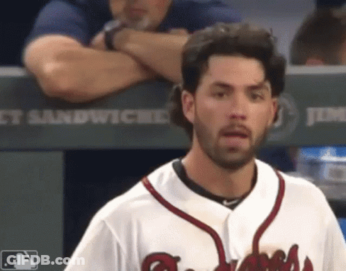 A Baseball Player Stands In Front Of A Dugout That Says Jimmy Sandwiches GIF