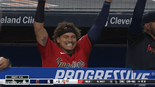 A Baseball Player Stands In Front Of A Progressive Ad GIF