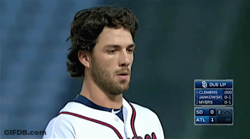 A Baseball Player Stands In Front Of A Scoreboard That Says Due Up On It GIF