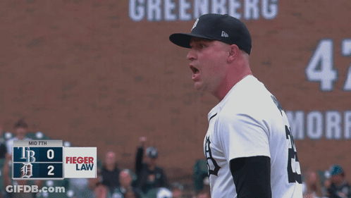 A Baseball Player Stands In Front Of A Scoreboard That Says Fieger Law On It GIF