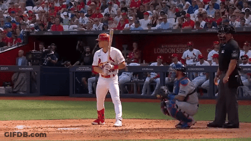 A Baseball Player Stands In Front Of A Sign That Says London Series On It GIF