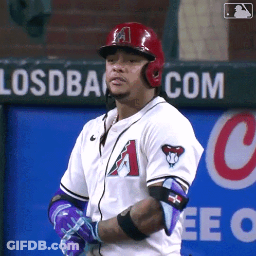 A Baseball Player Stands In Front Of A Sign That Says Losdback.com GIF