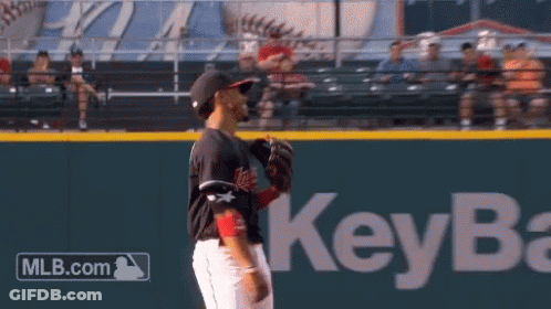 A Baseball Player Stands On A Field With A Key Bank Logo In The Background GIF