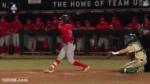 A Baseball Player Swings At A Pitch In Front Of A Sign That Says The Home Of Team U.s. GIF