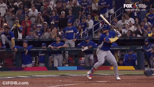 A Baseball Player Swings At A Pitch While Fox Broadcasts The Game GIF
