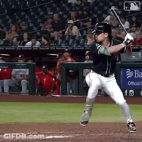A Baseball Player Swings His Bat At A Ball In Front Of A Banner That Says Ba GIF