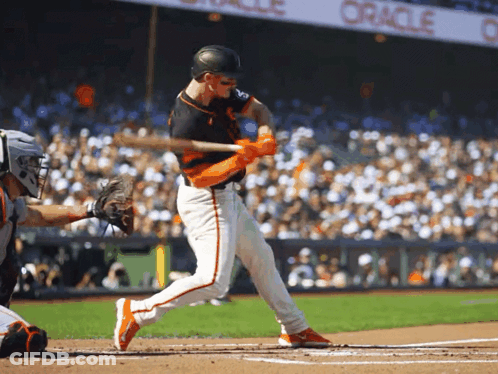 A Baseball Player Swings His Bat At A Pitch In Front Of An Oracle Banner GIF