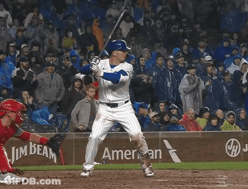 A Baseball Player Swings His Bat In Front Of A Beam America Sign GIF