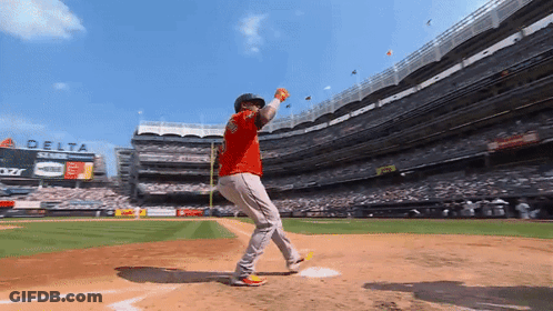 A Baseball Player Throws A Ball In Front Of A Delta Airlines Sign GIF