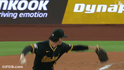 A Baseball Player Throws A Ball In Front Of An Advertisement For Dynair GIF