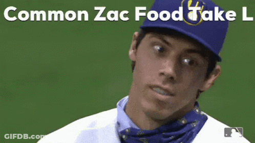 A Baseball Player Wearing A Bandana Around His Neck And A Blue Hat With The Words Common Zac Food Take L On It . GIF