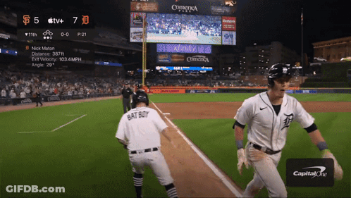 A Baseball Player Wearing A Bat Boy Jersey Is Running Towards The Base GIF