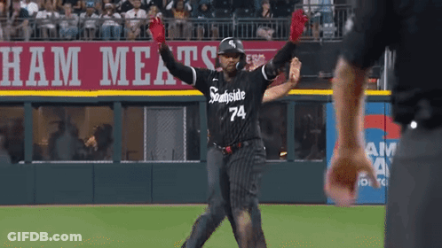 A Baseball Player Wearing A Black And White Uniform With The Number 74 On It GIF