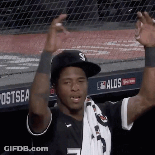 A Baseball Player Wearing A Black Hat And A White Scarf With The Number 7 On It GIF